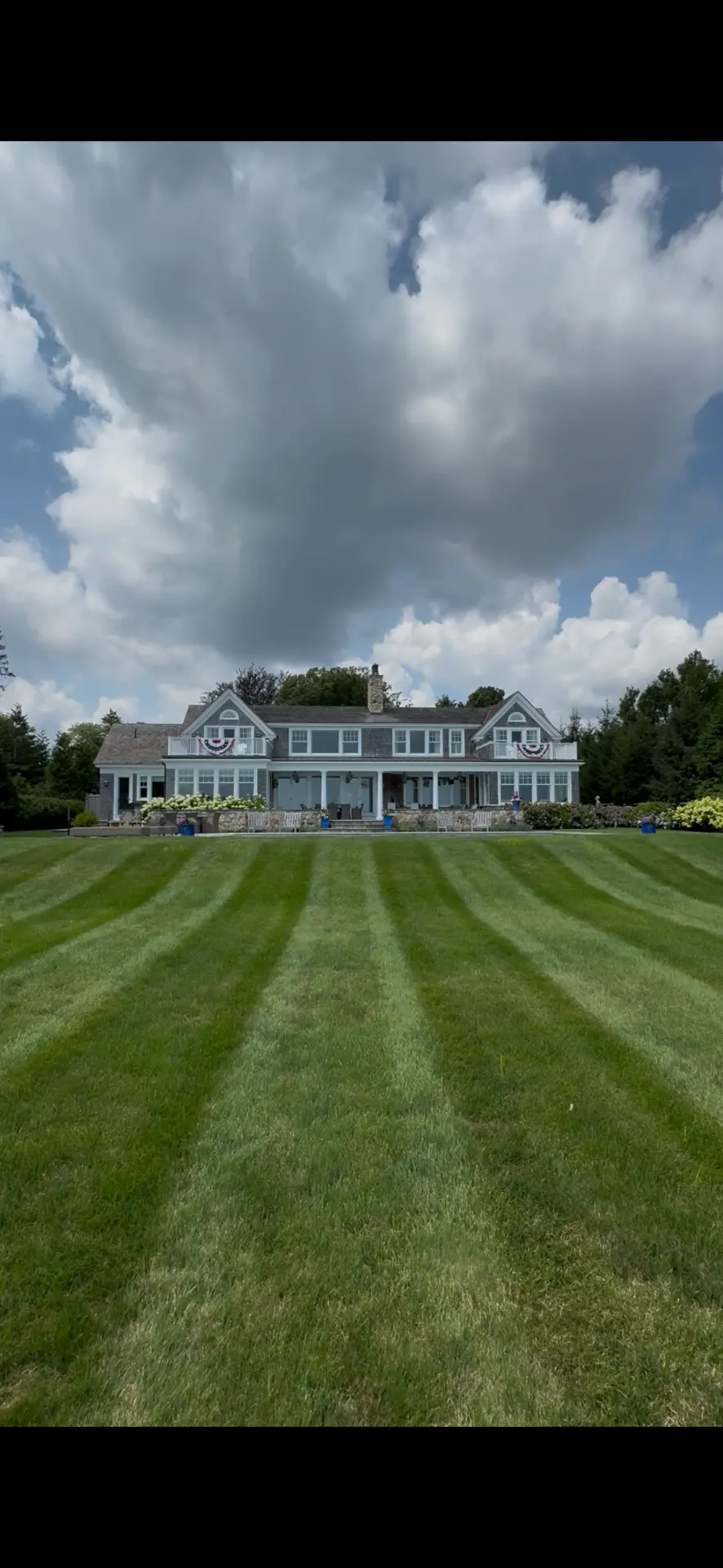 Large shingled estate home on the South Shore with a striped lawn